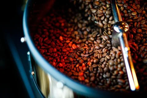 Coffee beans in a coffee machine, in dark colors. Stock Photos