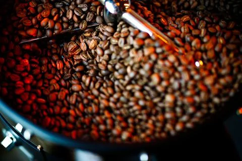 Coffee beans in a coffee machine, in dark colors. Stock Photos