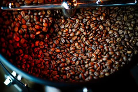 Coffee beans in a coffee machine, in dark colors. Stock Photos