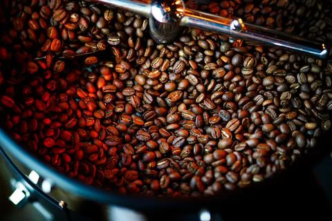 Coffee beans in a coffee machine, in dark colors. Stock Photos