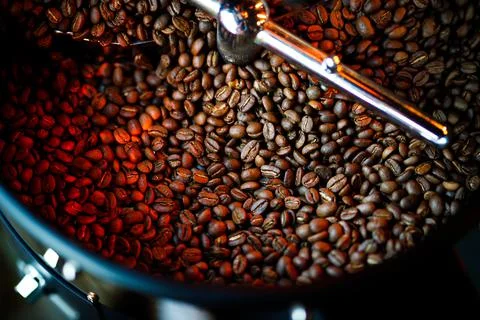 Coffee beans in a coffee machine, in dark colors. Stock Photos