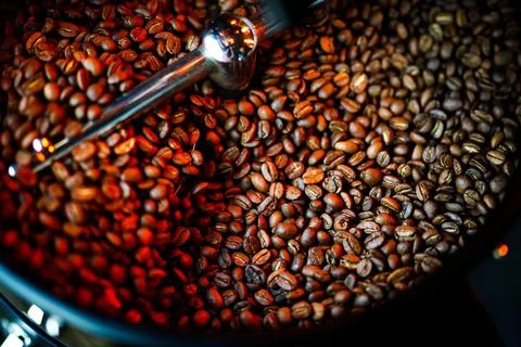 Coffee beans in a coffee machine, in dark colors. Stock Photos