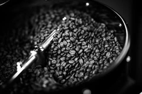 Coffee beans in a coffee machine, in dark colors. Stock Photos