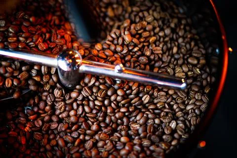 Coffee beans in a coffee machine, in dark colors. Stock Photos