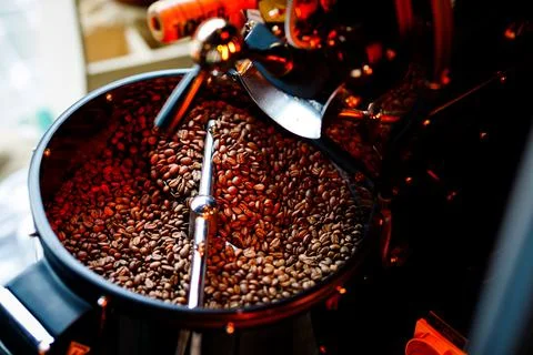 Coffee beans in a coffee machine, in dark colors. Stock Photos