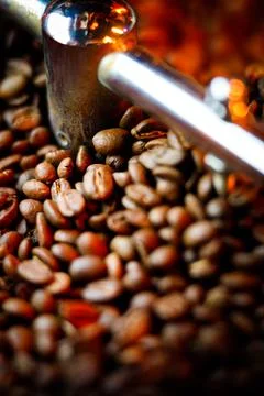 Coffee beans in a coffee machine, in dark colors. Stock Photos