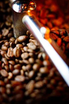 Coffee beans in a coffee machine, in dark colors. Stock Photos