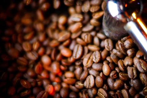 Coffee beans in a coffee machine, in dark colors. Stock Photos