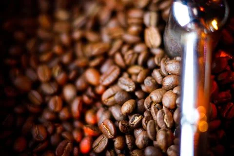 Coffee beans in a coffee machine, in dark colors. Stock Photos