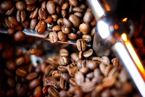 Coffee beans in a coffee machine, in dark colors. Stock Photos