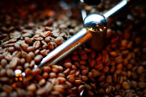 Coffee beans in a coffee machine, in dark colors. 库存照片