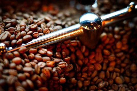 Coffee beans in a coffee machine, in dark colors. Stock Photos