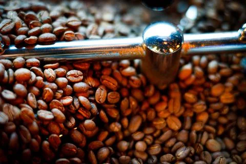 Coffee beans in a coffee machine, in dark colors. Stock Photos