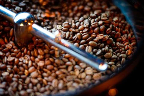 Coffee beans in a coffee machine, in dark colors. Stock Photos