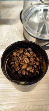 Coffee beans in the coffee maker Stock Photos