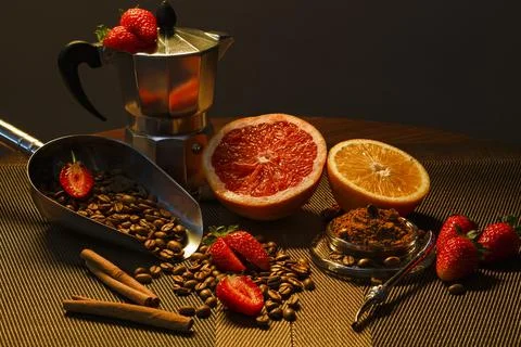 Coffee beans composition with grapfruit, orange, strawberry and coffee grinder Stock Photos
