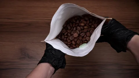 Coffee Beans in Craft Packaging in Human Hands Stock Footage 263227022