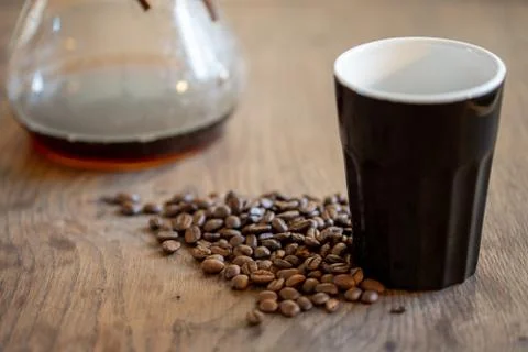 Coffee beans in cup on beans background Stock Photos