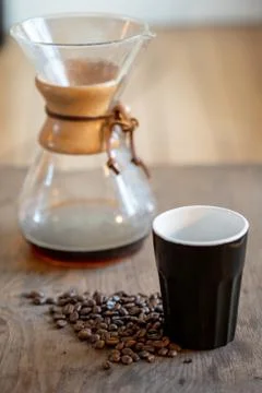 Coffee beans in cup on beans background Stock Photos