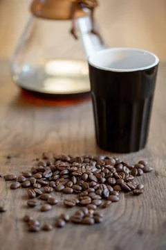 Coffee beans in cup on beans background Stock Photos