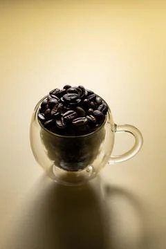 Coffee beans in a cup isolated on plain background Foto stock