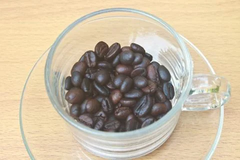 Coffee beans in cup Stock Photos