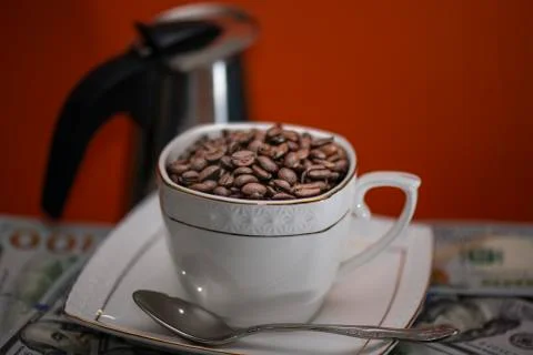 Coffee beans in Cup on red background Stock Photos