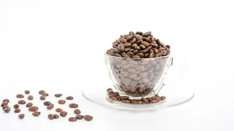 Coffee beans in a cup on a white background. Stock Photos