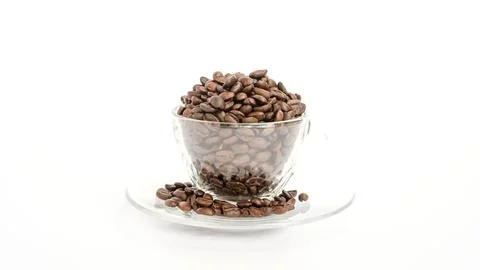 Coffee beans in a cup on a white background. Stock Photos