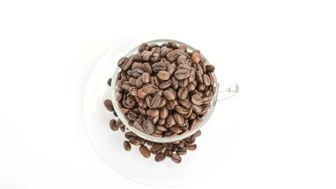 Coffee beans in a cup on a white background. Stock Photos