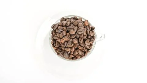 Coffee beans in a cup on a white background. Stock Photos