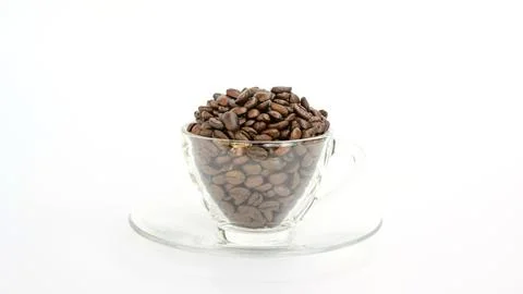 Coffee beans in a cup on a white background. Stock Photos