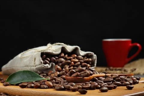 Coffee beans on a cutting board.concret background 스톡 사진
