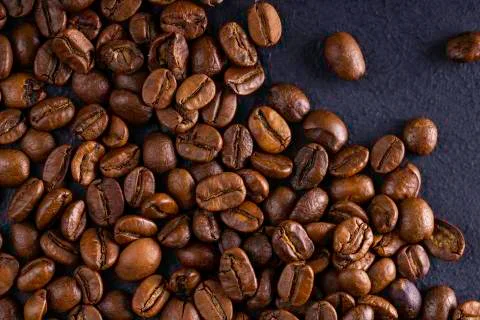 Coffee beans on dark background. Stock Photos
