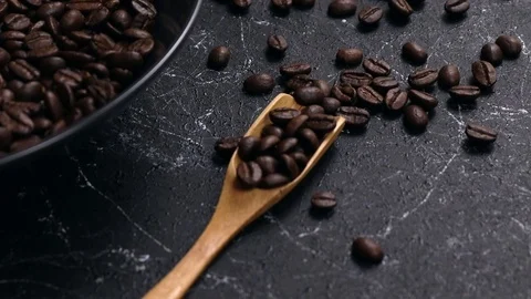 Coffee beans in dark cup on mixed coffee beans background Stock Footage 129614817