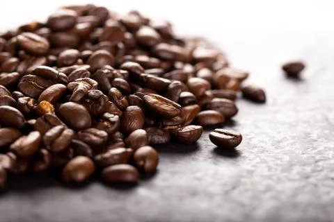 Coffee beans on dark stone table. Stock Photos