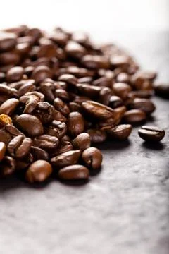 Coffee beans on dark stone table. Stock Photos