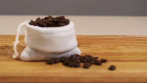 Coffee beans defocus in a white pouch close-up on a 4K cutting board Stock Footage 113052436