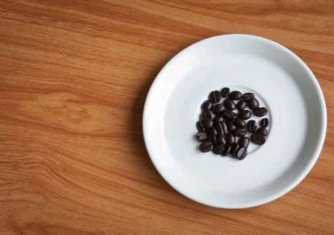 Coffee beans on a disk . Stock Photos