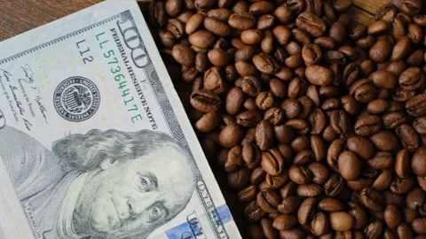 Coffee beans on dollars in close-up Stock Footage 277993744