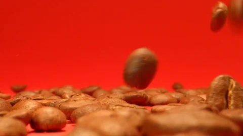 Coffee Beans Dropping on a Red Background in Slow Motion Stock Footage 126723585