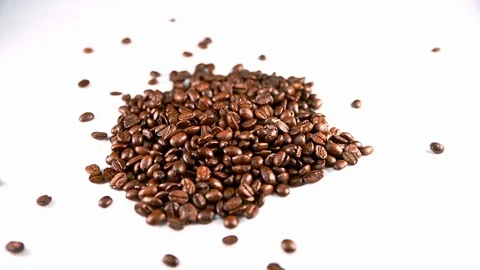 Coffee beans dropping onto a white isolated background Stock Footage 126015960