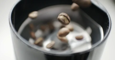 Coffee beans drops in the grinder Stock Footage 104406291