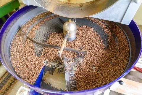 Coffee beans during the roasting process. Drum type roaster. Rosting process  Photos