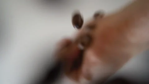 Coffee beans fall directly into the camera Video stock 185420596