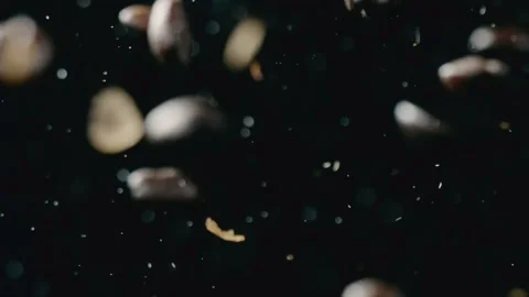 Coffee beans fall down and a fire blazes in the background Stock Footage 253407940
