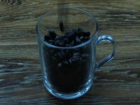 Coffee beans fall into glass cup Stock Footage 80302047