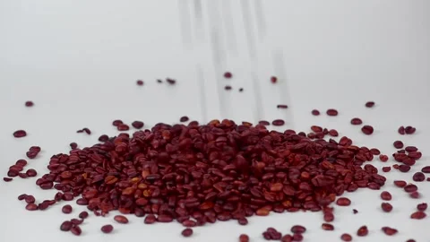 Coffee beans fall on a light surface.Roasted coffee beans fall Stock Footage 254116586