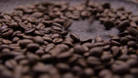 Coffee beans fall on an old metal brazier. Slow motion and close up Video stock 131967000