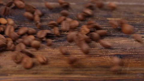 Coffee beans fall in slow motion on the board Stock Footage 113084326